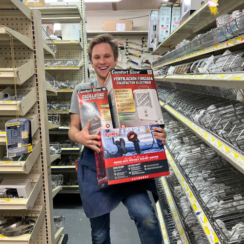 Benton's staff member holding seasonal applies inside the store.