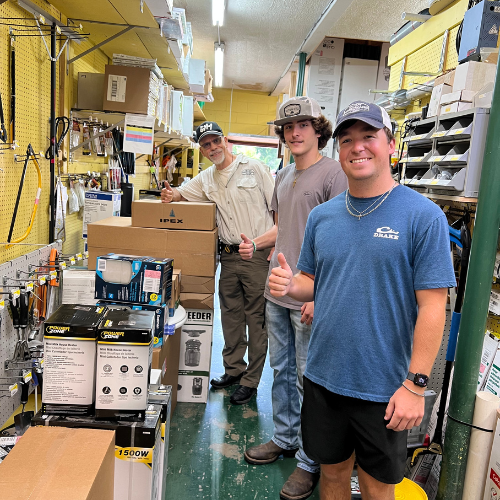 Benton's staff members posing and smiling inside the store.