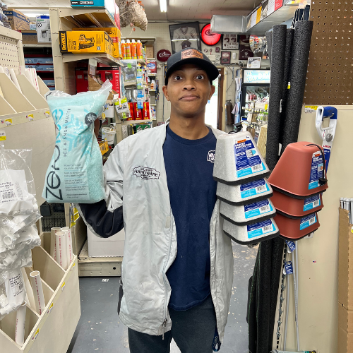 Benton's staff member holding seasonal applies inside the store.