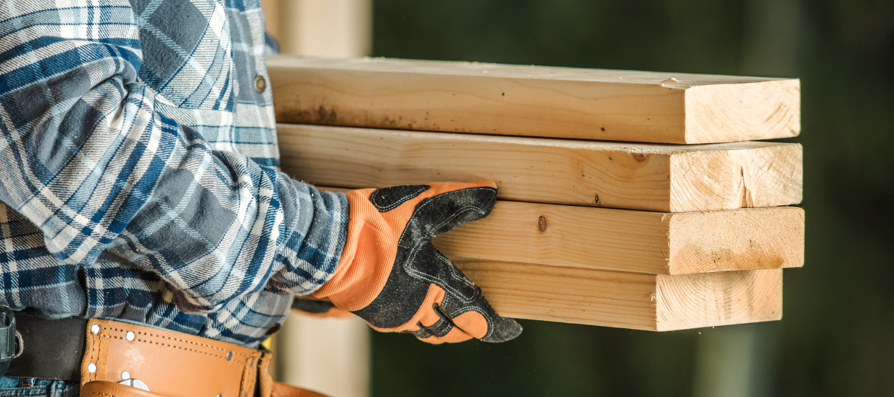 Contractor carrying lumber